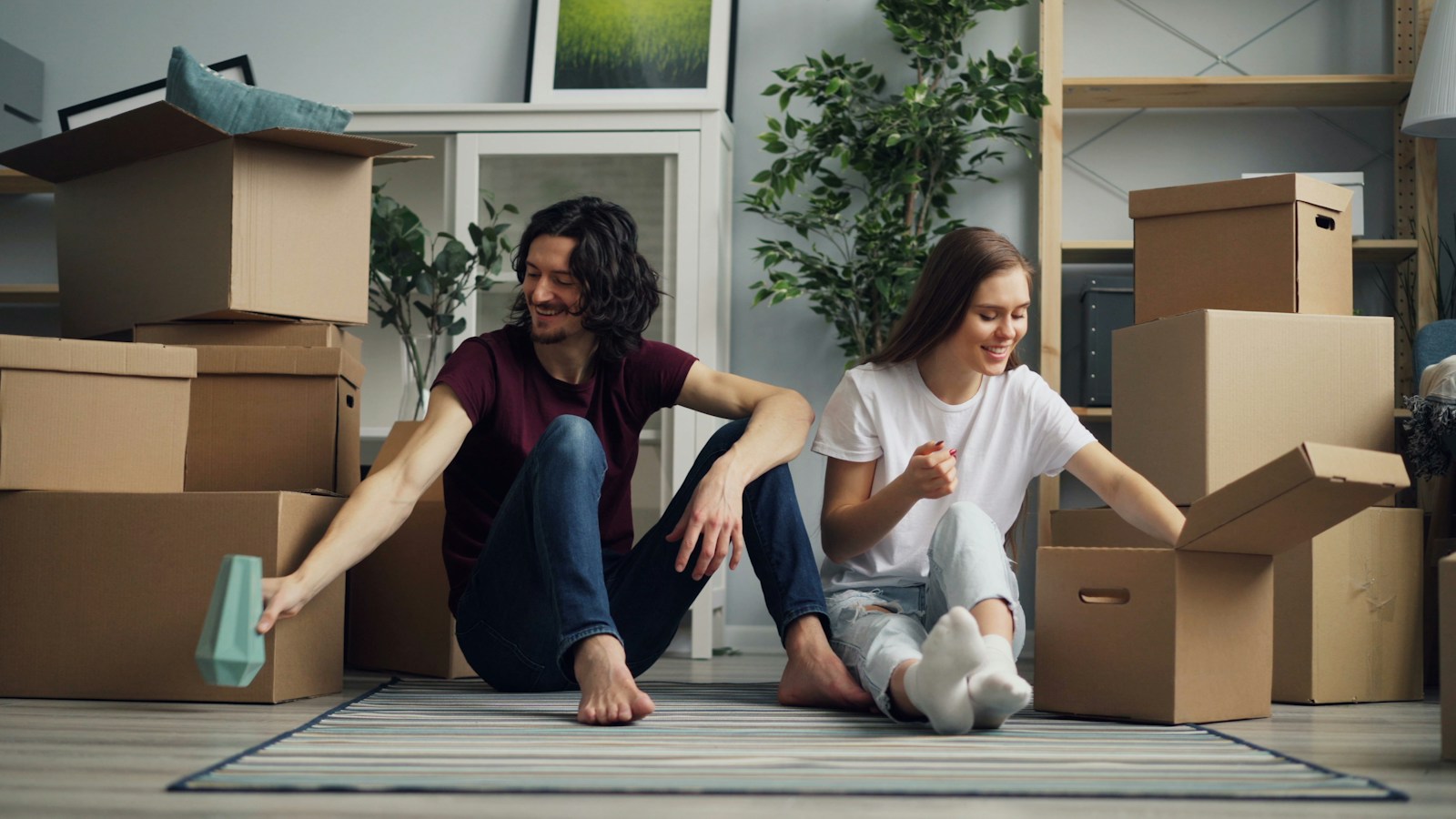 A couple unpacking moving boxes in their new home